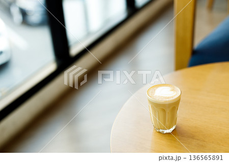 Cup of coffee latte art on wood table. 136565891