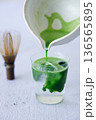Iced matcha drink with water in a glass. 136565895