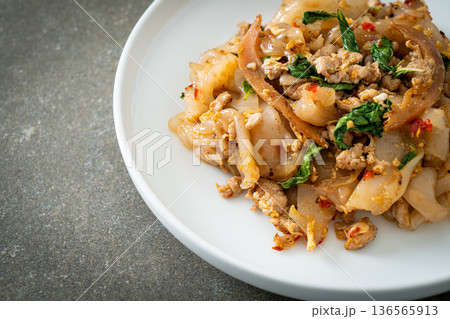 Stir-fried noodle with minced chicken and basil Stir-fried noodle with minced chicken and basil 136565913