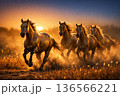 Three powerful horses galloping across an open landscape at sunset with dramatic sky and dust motion. 136566221