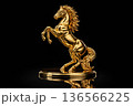 Golden horse sculpture captured in dramatic warm lighting symbolizing prosperity and strength 136566225