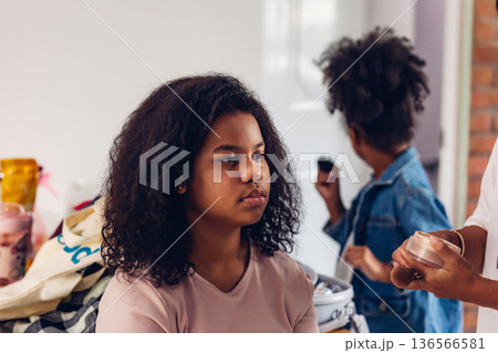 Stylist is putting make up on black woman eyebrows with the eyebrows brush. Stylist is putting make up on black woman eyebrows with the eyebrows brush. 136566581