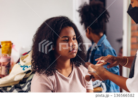 Stylist is putting make up on black woman eyebrows with the eyebrows brush. Stylist is putting make up on black woman eyebrows with the eyebrows brush. 136566582