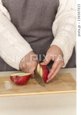 キッチンでりんごの皮をむくシニア女性の手元 キッチンでりんごの皮をむくシニア女性の手元 136567815