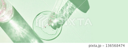 Laboratory glassware with petri dish and pipette on light green background Laboratory glassware with petri dish and pipette on light green background 136568474