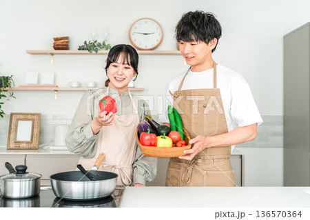 キッチンで野菜を持つ若いアジア人男女,カップル,夫婦 キッチンで野菜を持つ若いアジア人男女,カップル,夫婦 136570364
