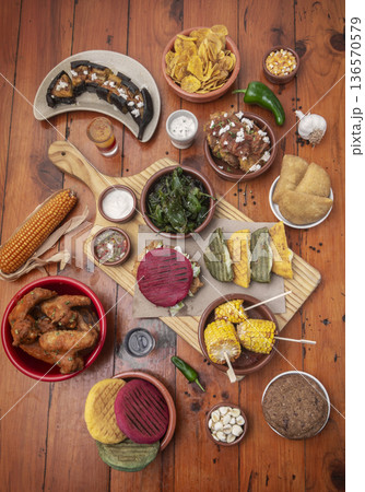 mixed colombian and venezuelan food meal spread on wooden restaurant table mixed colombian and venezuelan food meal spread on wooden restaurant table 136570579