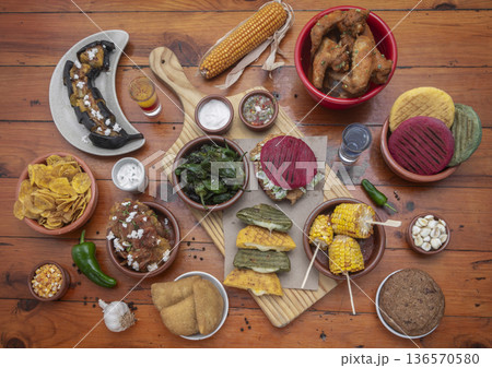 mixed colombian and venezuelan food meal spread on wooden restaurant table mixed colombian and venezuelan food meal spread on wooden restaurant table 136570580