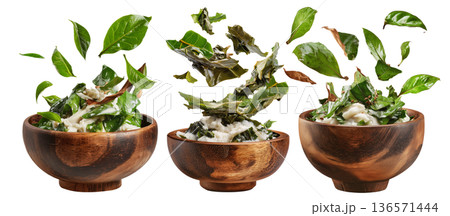 Rourou cooked taro leaves in creamy coconut milk, served in wooden bowl with garnishes, isolated on white background, Fiji cuisine 136571444