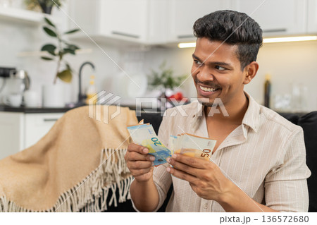 Indian man counts euro cash happy makes money gesture plans dream purchase savings bonus invest plan 136572680