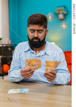 Indian man counts euro money cash banknotes feels wealthy salary profit extra winnings game jackpot Indian man counts euro money cash banknotes feels wealthy salary profit extra winnings game jackpot 136572906