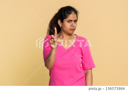 Indian woman shaking finger and head disapprovingly, showing clear no warning to camera Indian woman shaking finger and head disapprovingly, showing clear no warning to camera 136573984