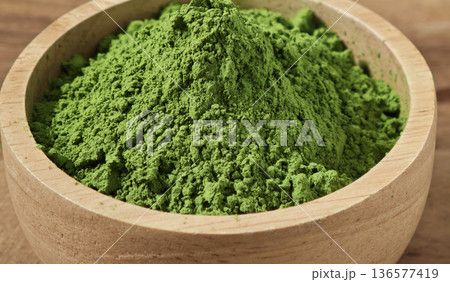 Matcha green tea powder in the wooden bowl Matcha green tea powder in the wooden bowl 136577419