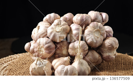 Close up Garlic herb in a basket on a wooden table. 136577509
