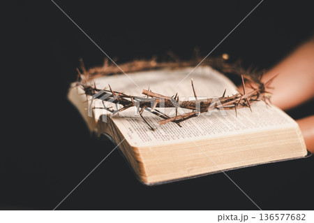 Hand offering an iron nail and crown of thorns on dark background, dramatic light with copy space, symbolizing crucifixion, sacrifice, Good Friday, Holy Week and Easter faith for believers worldwide. Hand offering an iron nail and crown of thorns on dark background, dramatic light with copy space, symbolizing crucifixion, sacrifice, Good Friday, Holy Week and Easter faith for believers worldwide. 136577682