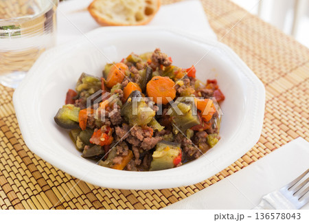 dish of vegetable stew. stewed eggplant, minced meat, carrots, peppers, onion squid 136578043