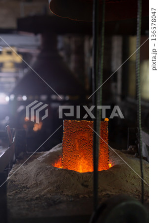 Ferrous metal billet is melted in an induction furnace closeup 136578047