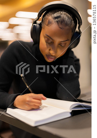 Focused Student Studying With Headphones Focused Student Studying With Headphones 136578115