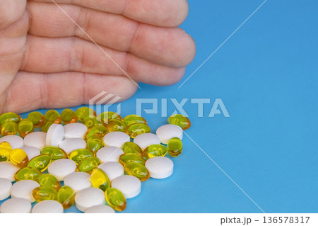 Hand Holding Pills And Capsules 136578317