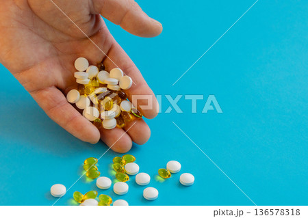Hand Holding Pills And Capsules 136578318