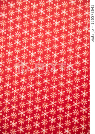 Red background with small snowflake pattern for christmas design Red background with small snowflake pattern for christmas design 136578643