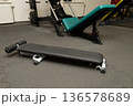 Gym equipment with bench press and workout machines in fitness center 136578689