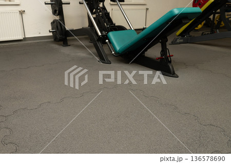 Empty gym interior with exercise equipment and puzzle mats 136578690