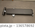 Flat workout bench on carpeted gym floor in fitness center 136578692