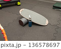 Balance board with foam roller and water bottle in gym setting 136578697