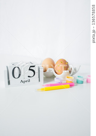 Christian Catholic Easter 2026 date on a wooden calendar with Easter eggs and paints for decoration on white background Christian Catholic Easter 2026 date on a wooden calendar with Easter eggs and paints for decoration on white background 136578858