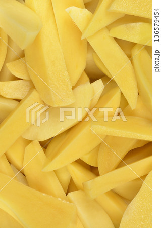 Peeled and Sliced Raw Yellow Potatoes Peeled and Sliced Raw Yellow Potatoes 136579454