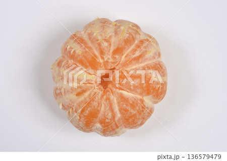 Peeled whole tangerine on white background 136579479