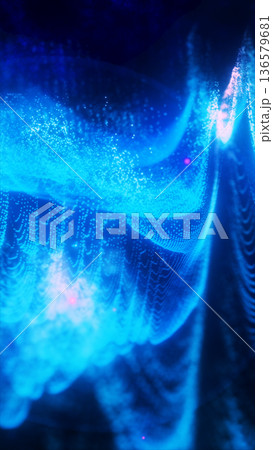 Dense shimmering blue digital particles forming a glowing wave-like structure across a dark scene Dense shimmering blue digital particles forming a glowing wave-like structure across a dark scene 136579681