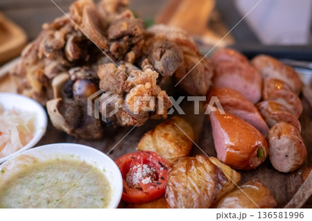 Crispy German pork knuckle with sausage served in the restaurant Crispy German pork knuckle with sausage served in the restaurant 136581996
