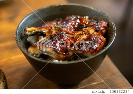 Unagi don. Grilled eel with sweet sauce rice bowl on wooden table. 136582284