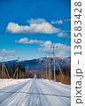 山へと続く真っ直ぐな冬の雪道 北海道の快晴の風景 136583428