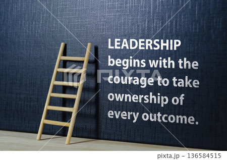 LEADERSHIP begins with the courage text on black cover with wooden ladder. LEADERSHIP begins with the courage text on black cover with wooden ladder. 136584515
