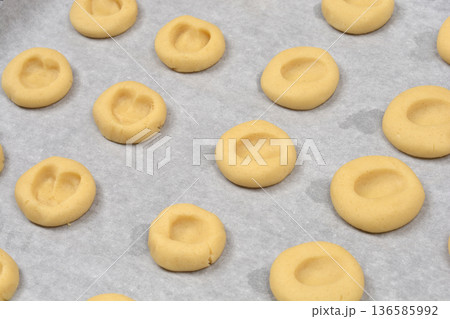 Raw thumbprint cookie dough on baking sheet 136585992