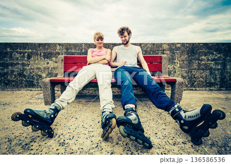 Young people friends relaxing on bench. 136586536