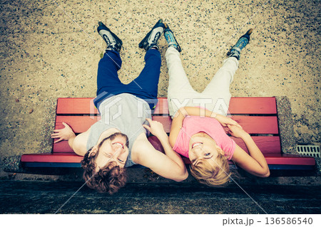 Young people friends relaxing on bench. Young people friends relaxing on bench. 136586540