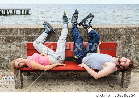 Young people friends relaxing on bench. 136586554