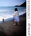 波打ち際を歩く女性 136586638