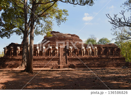 Ancient ruins Buddhist pagoda is decorated with elephant statues all around. 136586826