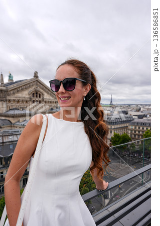 Smiling woman on Paris rooftop terrace Smiling woman on Paris rooftop terrace 136586851