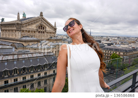 Woman enjoying city view from rooftop Paris Woman enjoying city view from rooftop Paris 136586868