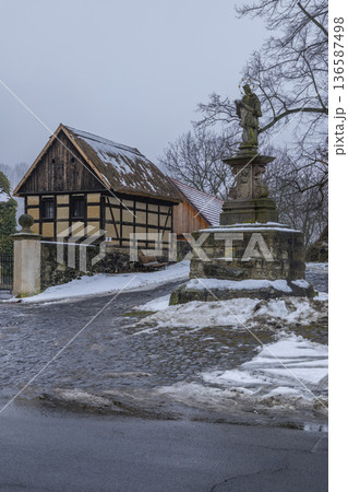 Zubrnice village street with timber frame house and baroque column Zubrnice village street with timber frame house and baroque column 136587498