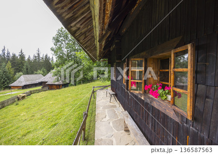 Traditional Slovak wooden house with flowers in Zuberec 136587563