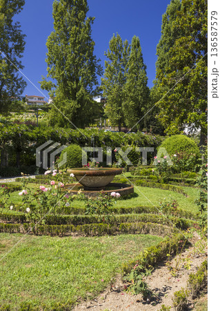 Stone fountain decorating formal garden in Cabeceiras de Basto 136587579