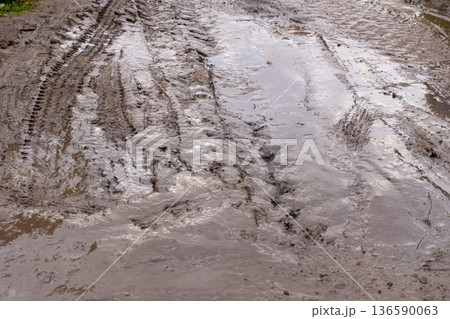 Muddy ground with tire tracks Muddy ground with tire tracks 136590063
