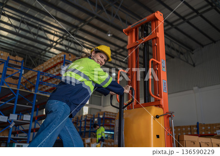 Warehouse worker working in warehouse storage.  136590229